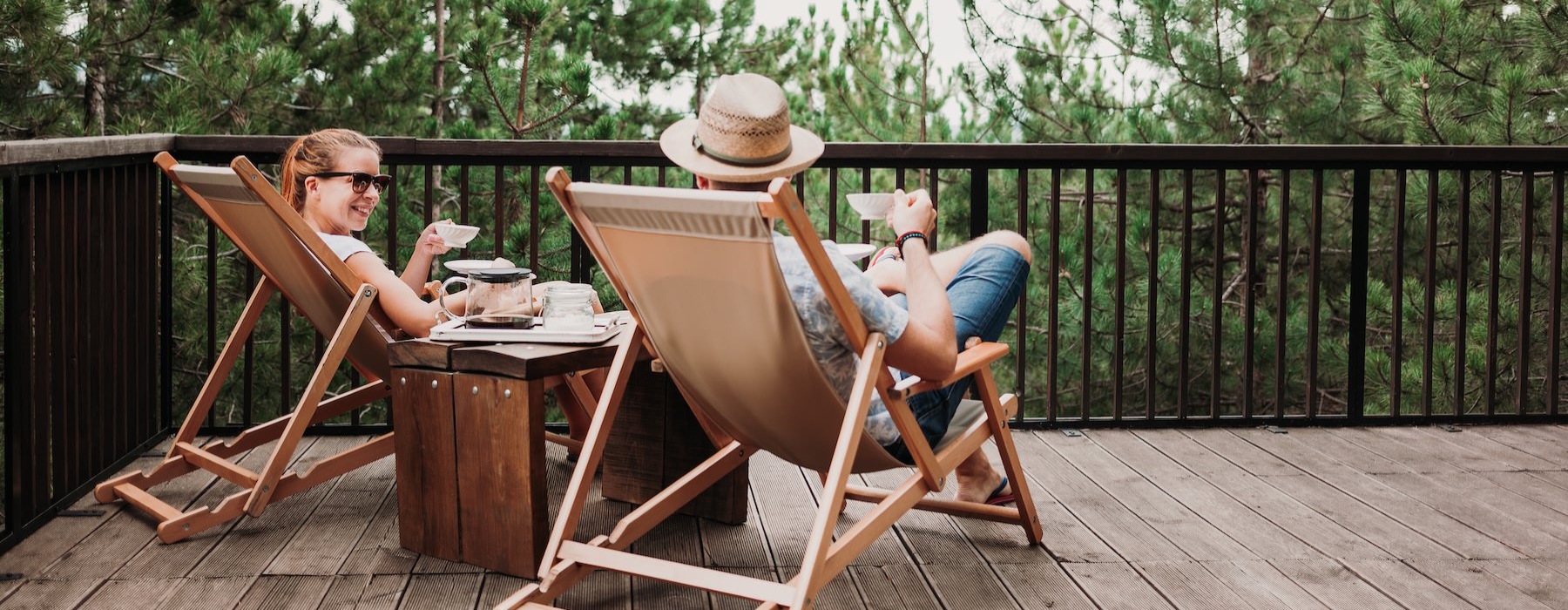 a couple of people sitting at a table outside