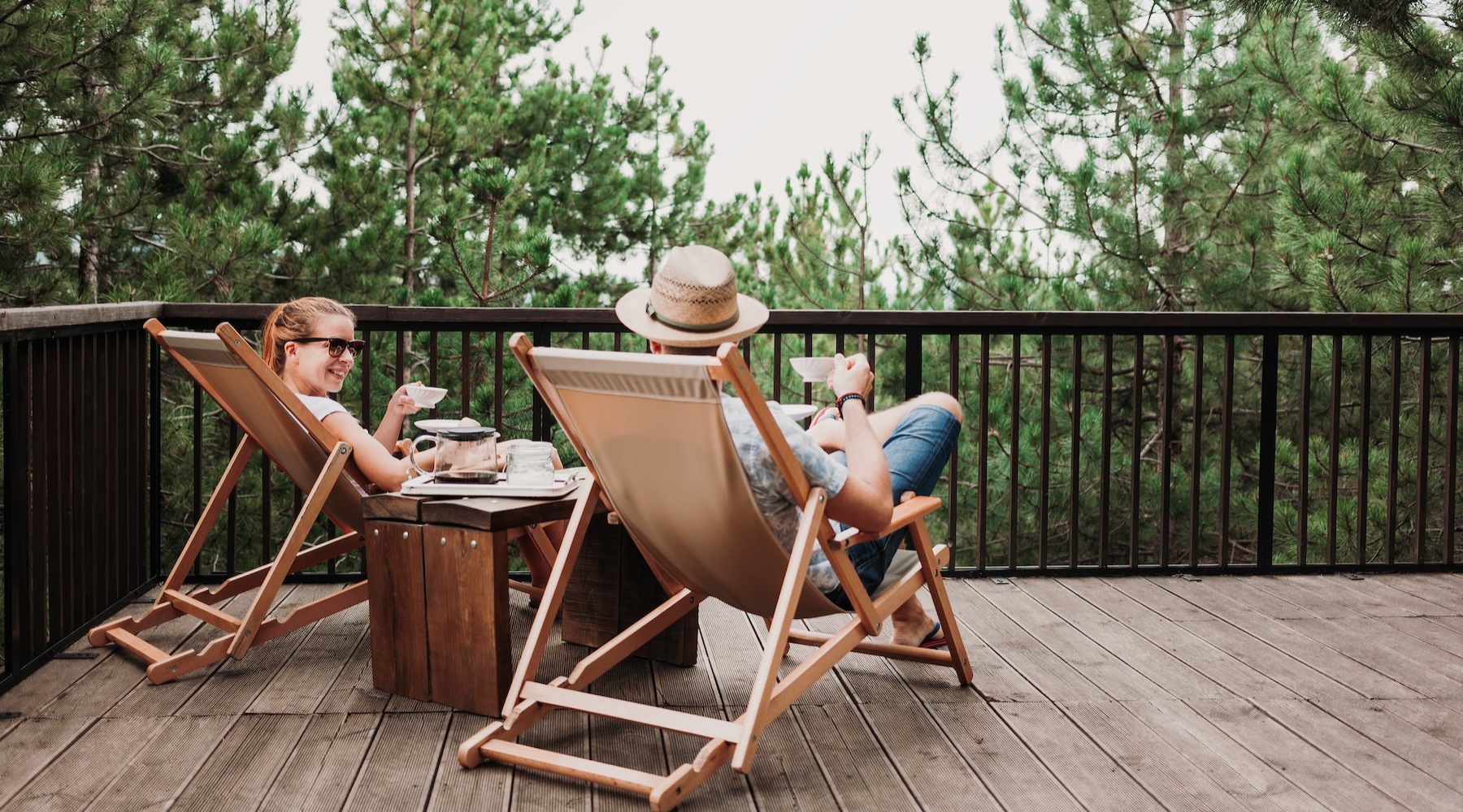 a couple of people sitting at a table outside