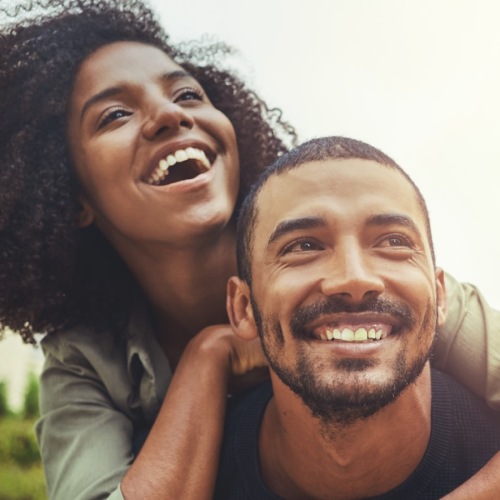 a man giving a woman a piggy back ride