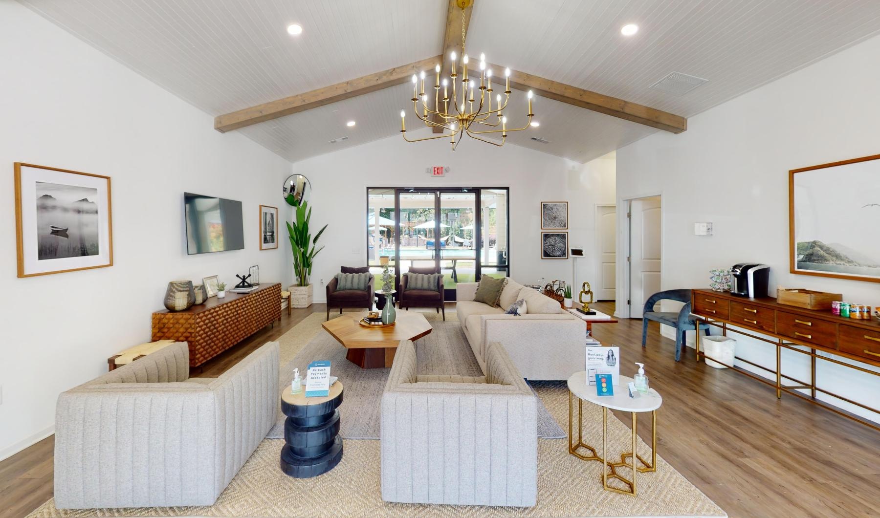 a clubroom with couches, tables and chairs