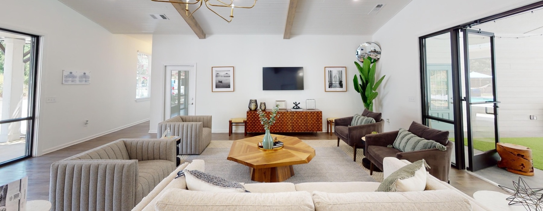 a clubroom with a couch, tables and chairs