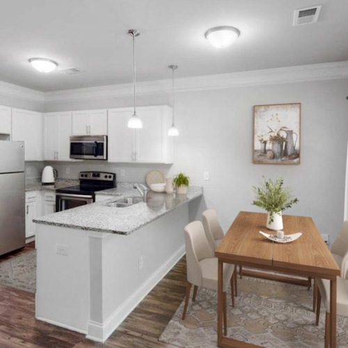 a kitchen with a dining table and chairs